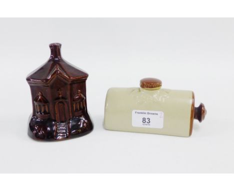 Brown glazed pottery money bank in the form of a house, 11cm high,  together with a small stoneware hot water flask, (2) 