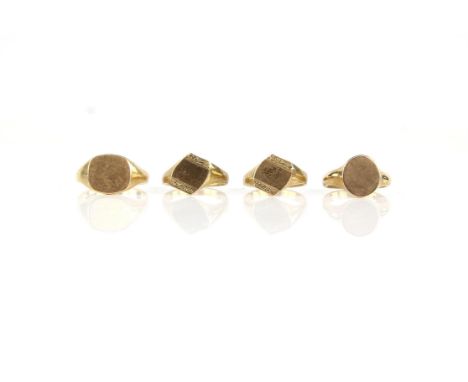 Four 9 ct gold signet rings, including an oval signet ring, size T, a cushioned shape signet ring, size W, and two asymmetric