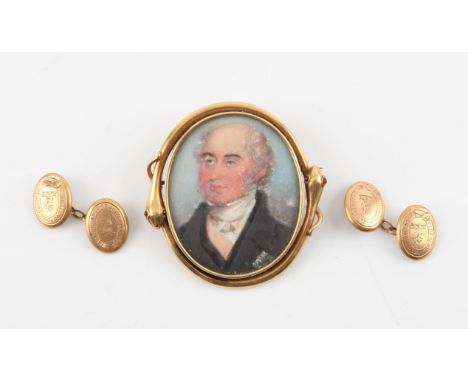 A miniature portrait pendant brooch, oval hand painted portrait of a gentleman, with a yellow metal frame in the form of two 