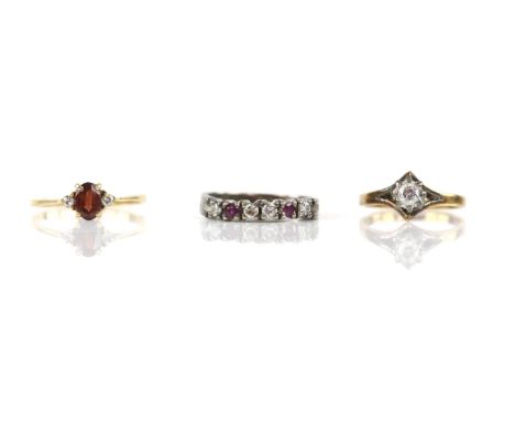 Three rings, a single stone diamond ring, mounted in 18 ct yellow gold, ring size G, a garnet and diamond three stone ring, m