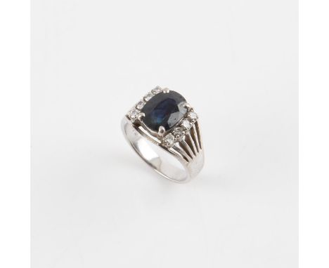 Sapphire and diamond ring, with a central oval faceted blue sapphire, estimated weight 3.68 carats, with four round brilliant