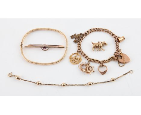 Selection of gold items, including a charm bracelet with a heart padlock clasp and safety chain, with four charms and one non