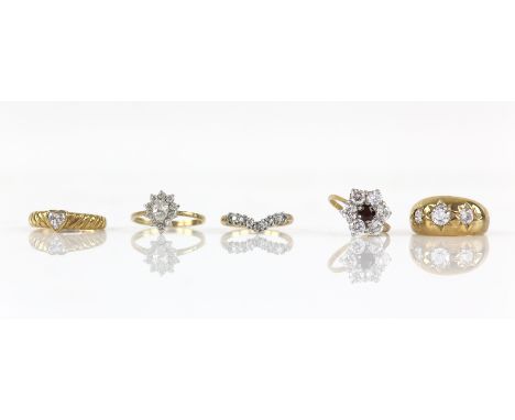 Five paste set rings, including an antique style three stone ring, size O, a single stone heart ring, size N, a red and white