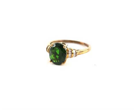 Chrome diopside and diamond ring, oval cut green diopside, estimated weight 3.18 carats, with two rows of baguette cut diamon