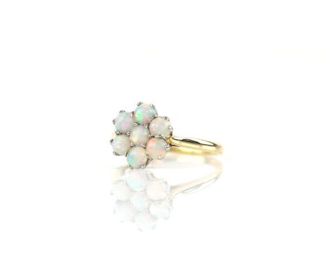 Opal cluster ring, seven round cabochon cut opals, mounted in stamped 18 ct yellow gold, ring size O½Condition Report:  Gross