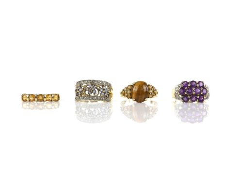 Four gem set rings, including an amethyst cluster ring, a tanzanite and diamond cluster ring, a five stone citrine ring and a