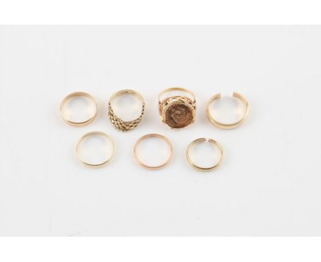 Seven gold rings, including a ring set with a John F. Kennedy coin, size P, a flexible brick link ring, size R, a 3mm wedding