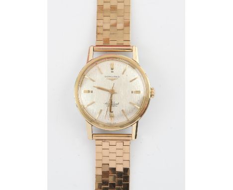Longines, a gentleman's Conquest automatic wristwatch, the signed dial with gold baton hour markers and centre seconds, fitte