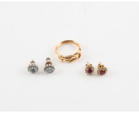 A knot design ring in 18 ct yellow gold, ring size M, together with a pair of ruby and cubic zirconia cluster earrings, and a