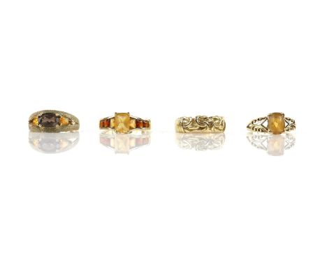 Four gem set rings including a single stone citrine ring, a five stone citrine ring, a three stone smoky quartz and citrine r