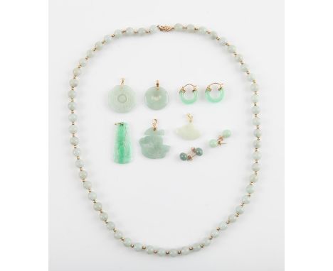 A selection of jade jewellery, including four pendants and a jade bead necklace, all with stamped 14 ct fittings, together wi