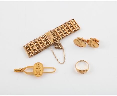 A  group of high carat gold jewellery items, including a signet ring with Chiinese symbols, a 20mm wide bracelet, and a tie s