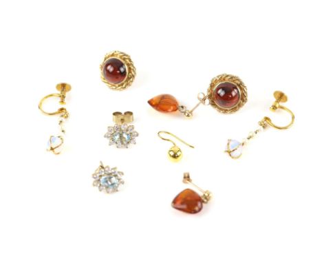 Four pairs of gem set earrings, including a pair of single stone garnet earrings, a pair of opal drop earrings, a pair of amb