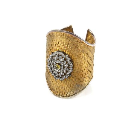 Large silver cuff bangle, woven design with a floral motif set with white paste stones and a central green cabochon paste sto