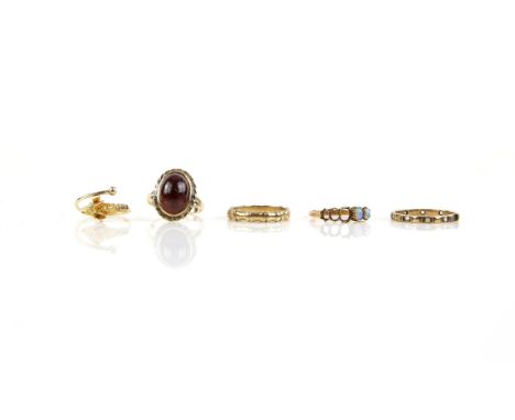 Five mixed rings, including an oval cabochon cut garnet, in a rubover setting, size O, a rams head design expandable ring, ap