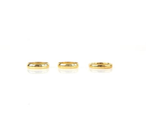 Three 18 ct yellow gold wedding bands, one measuring 3.5mm and two measuring 4mm, ring sizes L, M and NCondition Report:  Gro