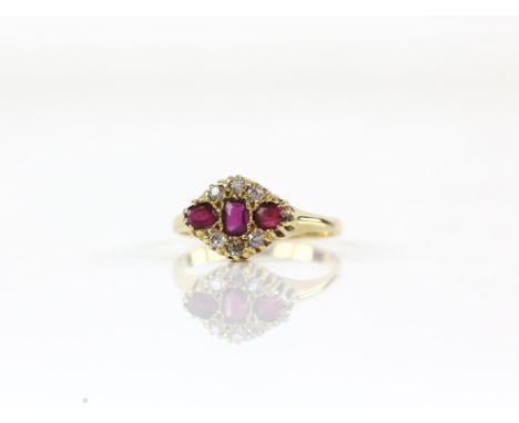 Edwardian ruby and diamond cluster ring, featuring, three rubies and six old cut diamonds, mounted in tested 18 ct yellow gol