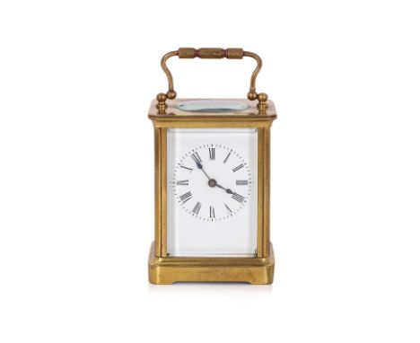 A GILT BRASS CARRIAGE CLOCK
.1st half 20th Century, the white enamel dial with Roman numeral chapter ring, gilt brass case wi