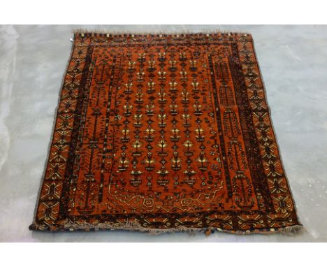 A TRIBAL WOOL RUG (180x130cm)
Hand knotted wool pile, central burnt orange field with an allover design of potted flowers
180