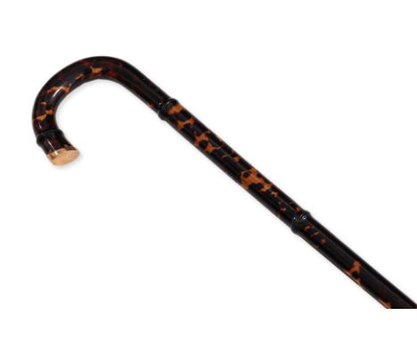 A GOLD MOUNTED AND FAUX TORTOISESHELL WALKING STICK
Bamboo moulded with faux tortoiseshell covering (cracked), the tip with a