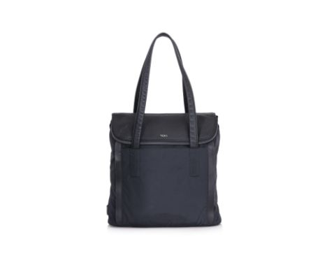A TUMI HAYDON CLARK TOTE
Navy nylon with black leather trim, dual leather handles, and gunmetal hardware. Zip-top closure wit