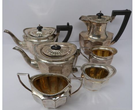 A silver six piece tea service with ebony handles and finial, coffee pot, tea pots, water jug, two milk jugs and sugar bowl, 