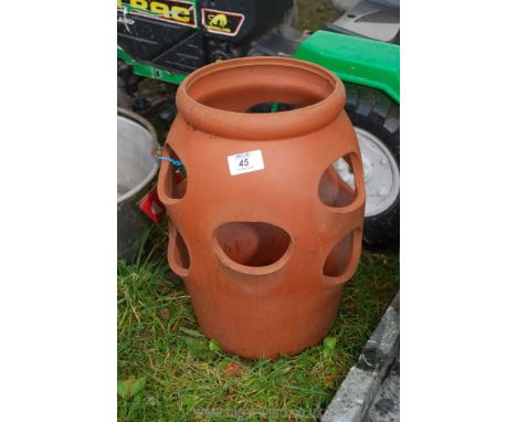 A terracotta herb/strawberry planter 14" tall.