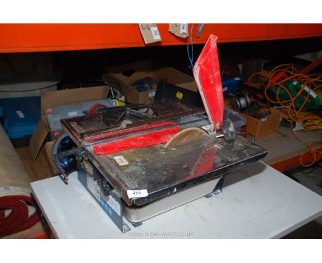An electric tile cutter, (running at time of lotting).