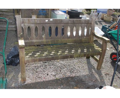 A wooden garden bench believed to be teak 5' wide x 3' high x 26" deep.