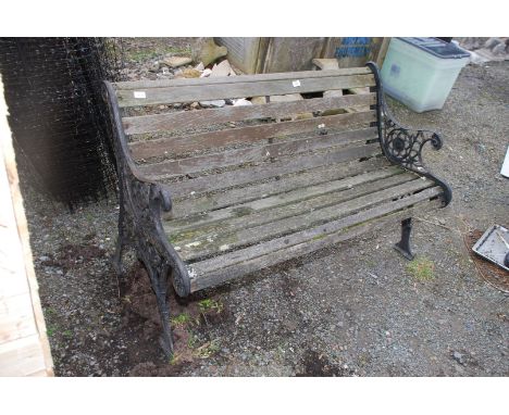 A wooden bench with metal ends 50" long x 30" high.