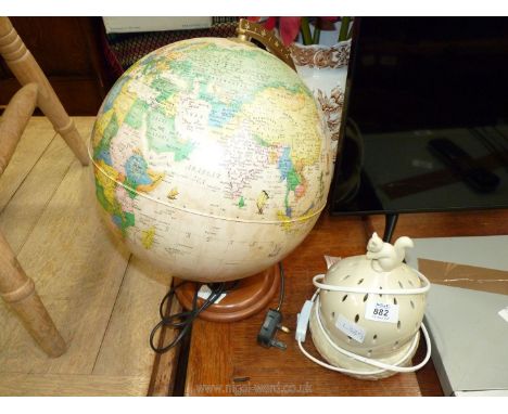 Modern illuminated globe and ceramic lamp.[Running at time of lotting]