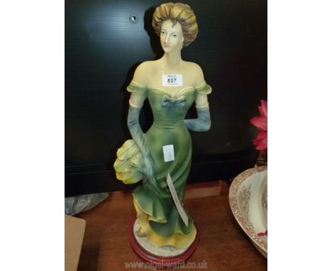 Ceramic figure of a lady in green dress, 24'' tall.  