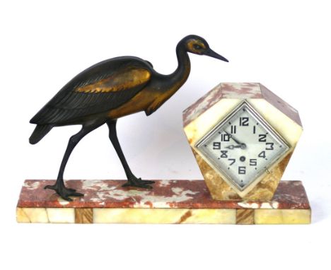 An Art Deco veined marble mantle clock
Having a gilt spelter heron beside a diamond shaped face, length 46cm.