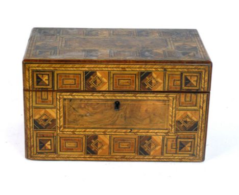 A Victorian inlaid walnut tea caddy
Of rectangular form, the hinged cover lifts to enclose two storage compartments, length 2