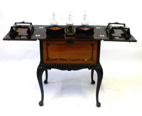 A fine quality Edwardian walnut and part ebonised pop-up drinks cabinet
The rectangular shaped top decorated with a pair of s