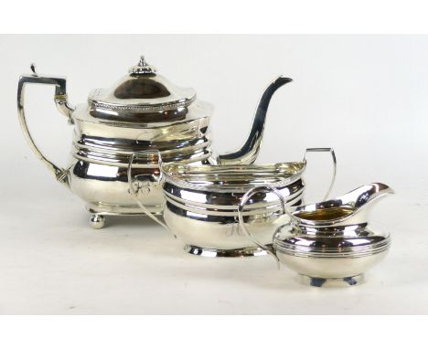 A George III matched silver three-piece tea service, various dates and makers 
The teapot, of shaped rectangular form, with a