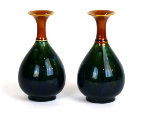 A pair of Arts & Crafts Linthorpe pottery vases of baluster form
Designed by Dr Christopher Dresser, decorated with green gla