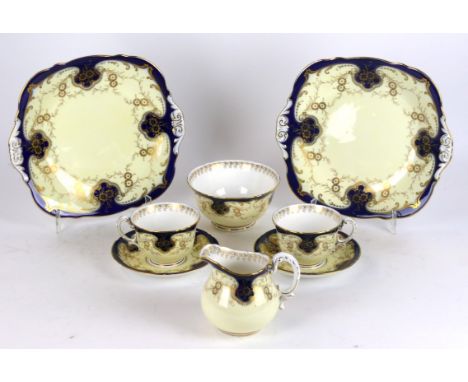 A Royal Worcester twelve setting tea service
Having gilt floral decoration on a blue and ivory ground, comprising two bread p