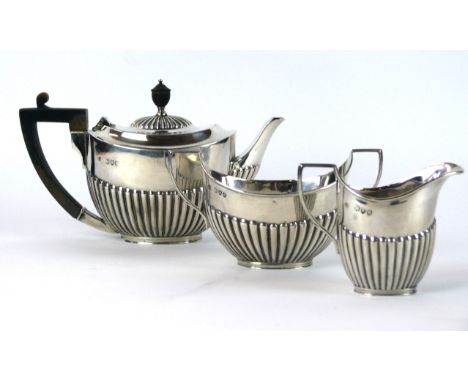 A Victorian silver bachelor's three-piece tea service, by William Hutton & Sons Ltd., London 1895
Of oval form, with an embos