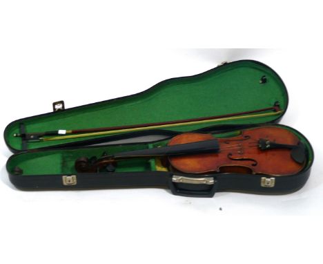 A mid 20th Century violin
In the form of a Stradivarius example, having carved scroll, complete with bow, fitted in carrying 