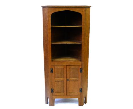 An Alan 'Acorn Man' Grainger adzed light oak corner cupboard
Having two fixed shelves, above two panelled doors, height 168cm