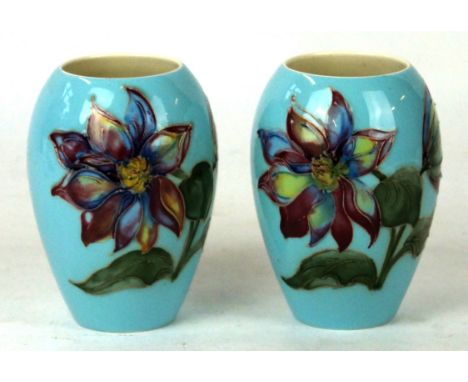 A Pair of Walter Moorcroft vases of ovoid form
Decorated in the Laelia Autumnalis pattern on a light blue ground, impressed f