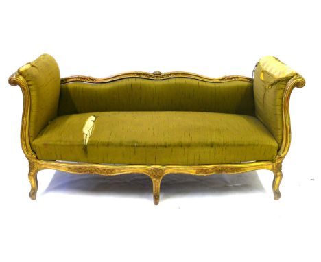 A 19th Century French-style carved giltwood framed day bed
The shaped low raised back flanked by scrolled high ends, raised o