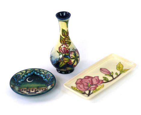 Three pieces of Moorcroft pottery 
To include a baluster vase decorated in a Sweet-Briar pattern, factory marks to base, heig