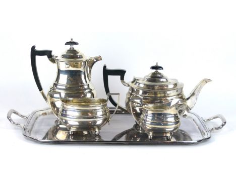 A hallmarked silver four piece tea service
Comprising tea pot, hot water jug, twin handled sugar bowl, milk jug, each of plai