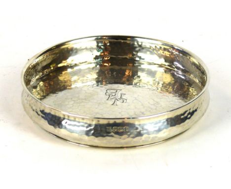 An Art & Crafts silver wine coaster, by Cooper Brothers & Sons Ltd, Sheffield 1928
Of shaped circular form, with spot-hammere