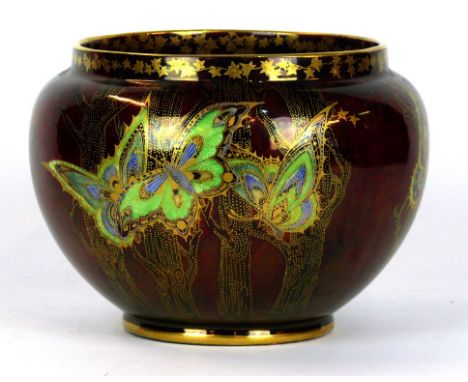 A Crown Devon Fieldings lustre jardinière
Decorated with butterflies and insects on a ruby ground, printed factory marks to b