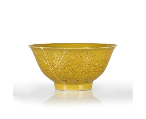 Yellow glazed 'Dragon' bowlChinesethe exterior is decorated with two incised dragons chasing a flaming pearl, the base with s