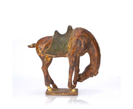 Glazed model of a horseChinese, Tang dynastythe horse with its head bowed to the left, on a rectangular base, 28cm long x 27c