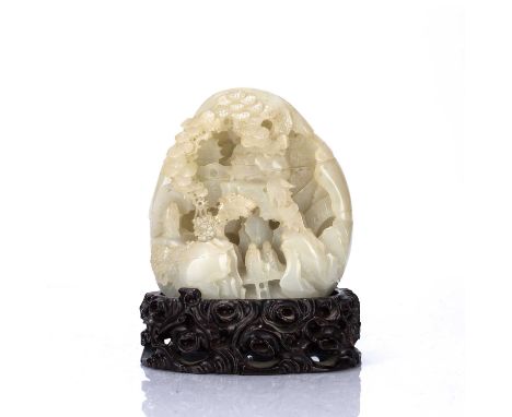 Carved jade boulderChinese, 19th Centurywith various scholars upon a bridge, beneath a rocky cavernous landscape with pine tr